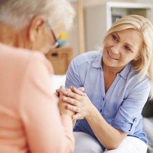 Caregiver helping senior client