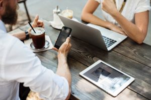 two people using IT MSP services to work remotely in a cafe