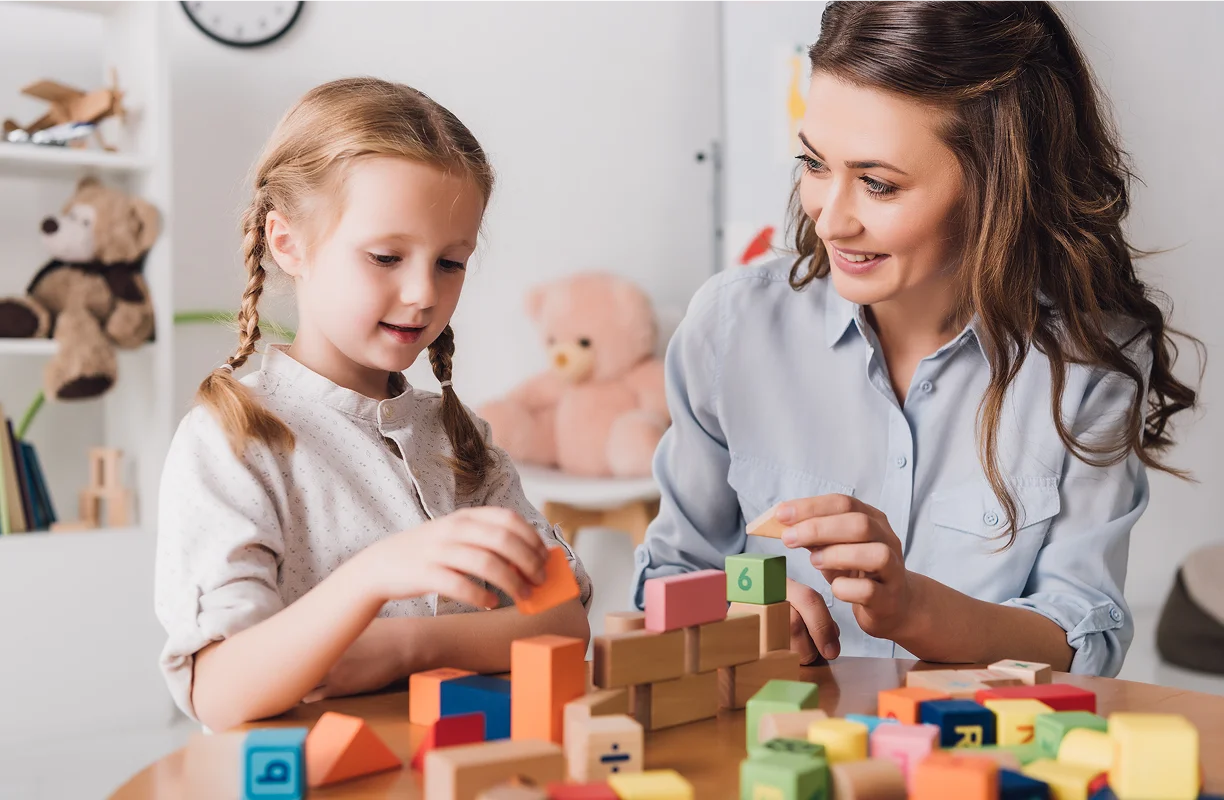 Mother and daughter playing with building blocks