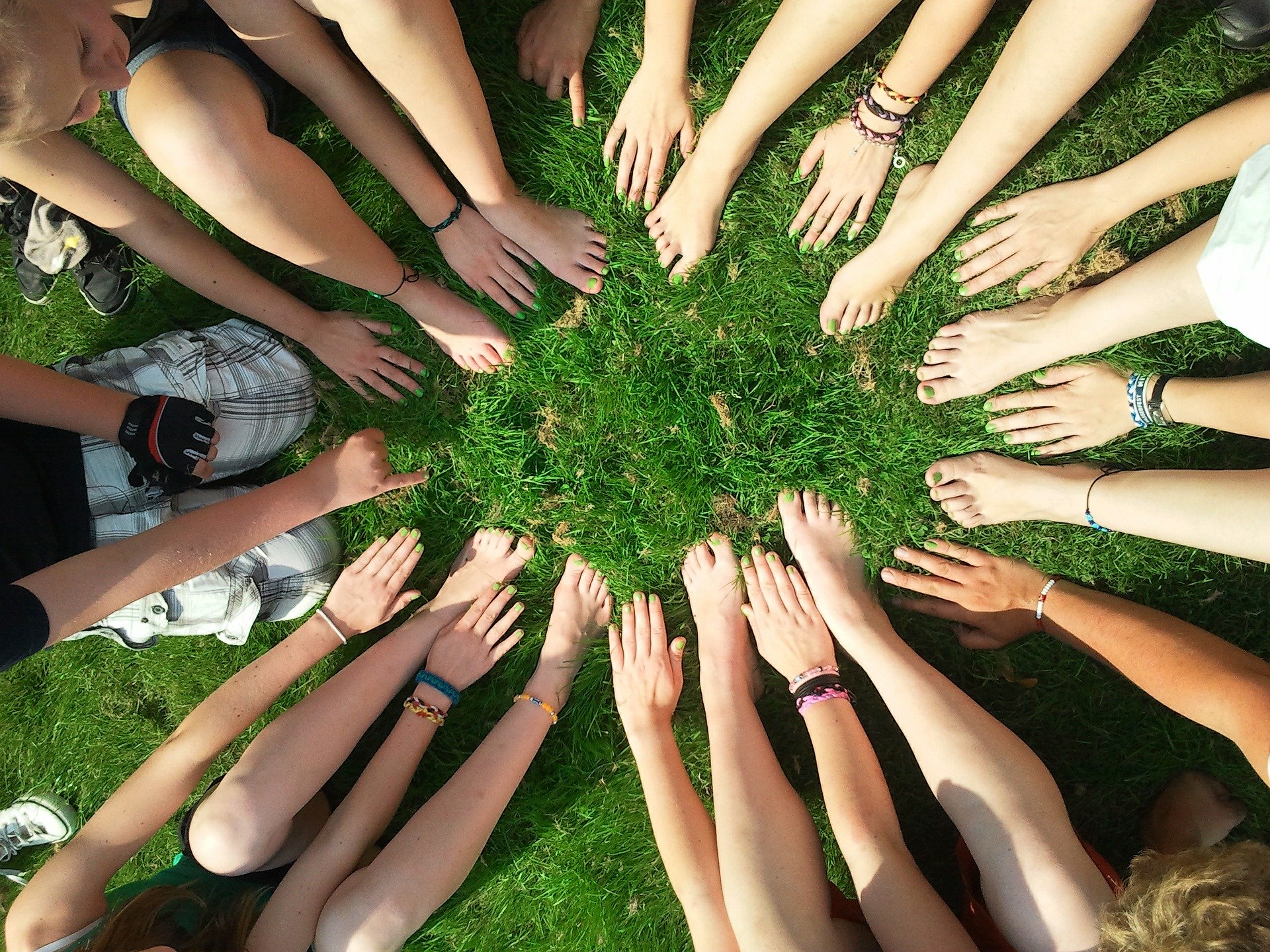 team mates networking in a circle with bare feet