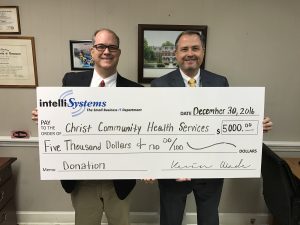 Kevin Wade, President and CEO of IntelliSystems, presents $5000 check to Jeff Drake of Christ Community Health Services of Augusta