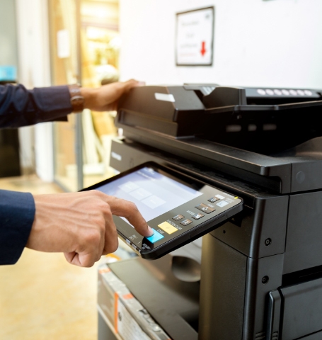 a person pressing printing machine bottom