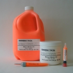 Image of Metron Ink shown in various packaging (Marker, Gallon, Pint, syringe, pneumatic cartridge, and air dispenses paint.