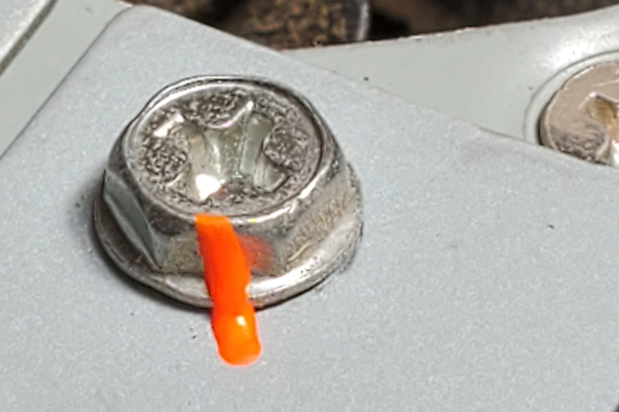 Image of Metron Orange Ink used on bolt for torque stripe, vibration aid, tamper marker, tamper pen, tamper proof paint, needle tip paint pen, permanent ink, and fluorescent orange marker.