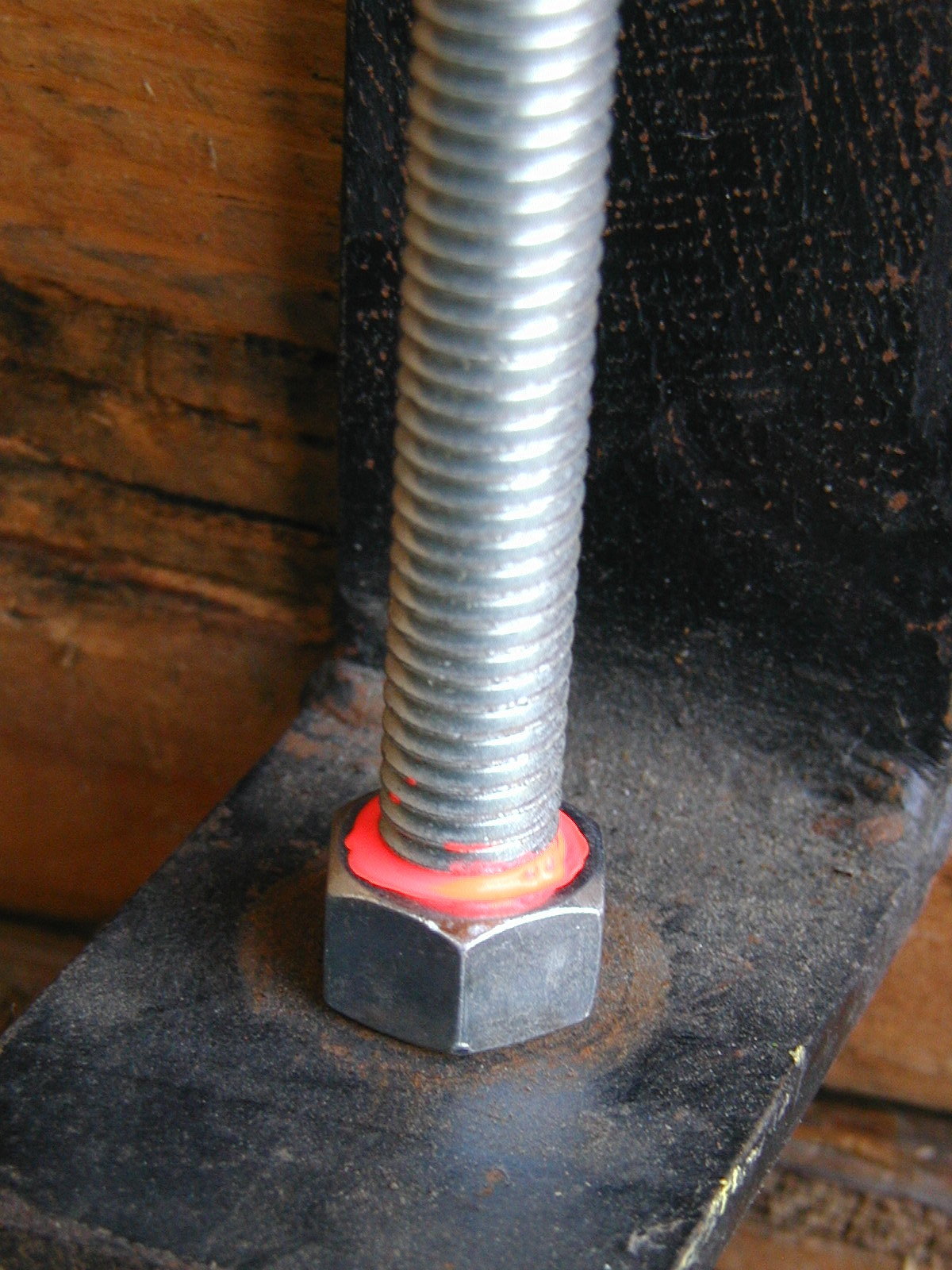  Image of bolt with nut at bottom striped with Metron Bright Orange paint to demonstrate use as tamper resistant, torque seal, or torque stripe.
